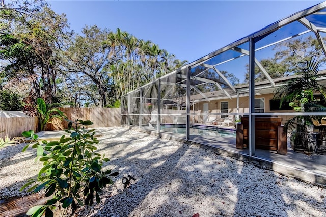 view of yard featuring a lanai, a fenced in pool, a patio, and a fenced backyard