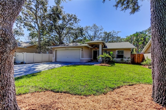 single story home featuring an attached garage, fence, a front yard, stucco siding, and driveway