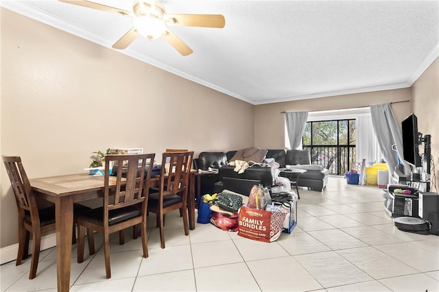 dining space with light tile patterned floors, ceiling fan, a textured ceiling, and crown molding