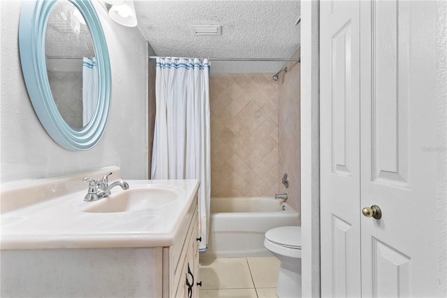 bathroom with a textured ceiling, toilet, vanity, tile patterned floors, and shower / bath combo with shower curtain