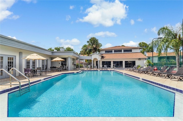 community pool featuring a patio and french doors