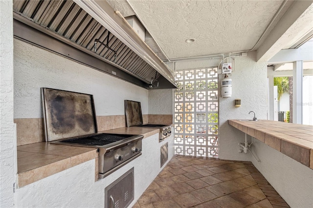 view of patio / terrace with a balcony and an outdoor kitchen