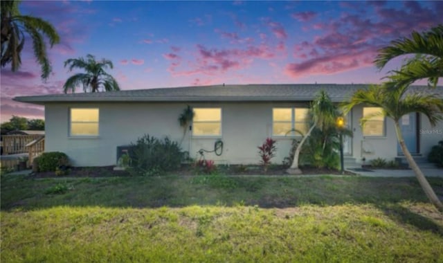 ranch-style home with a yard