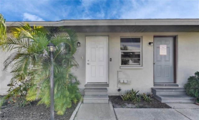 view of exterior entry with stucco siding