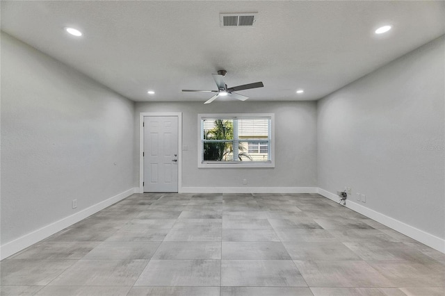 spare room with a ceiling fan, recessed lighting, visible vents, and baseboards