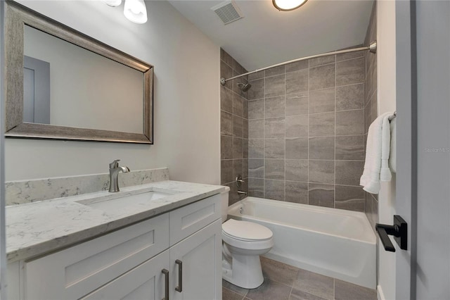 bathroom with toilet, vanity, visible vents,  shower combination, and tile patterned floors