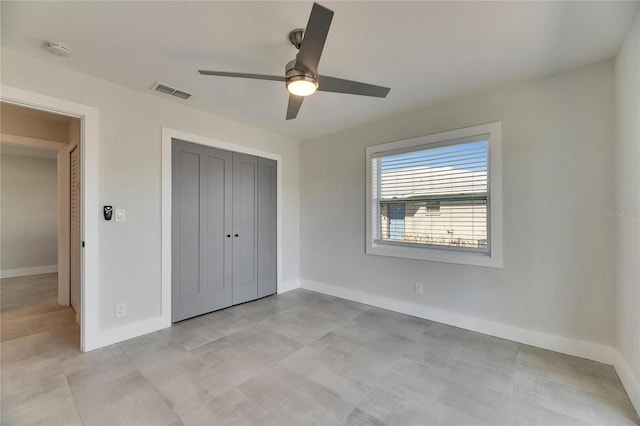 unfurnished bedroom with ceiling fan, a closet, visible vents, and baseboards