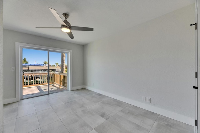 unfurnished room featuring ceiling fan and baseboards