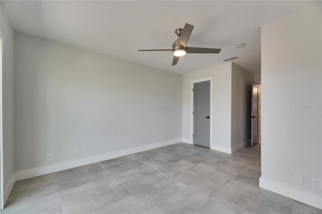 empty room featuring visible vents, ceiling fan, and baseboards