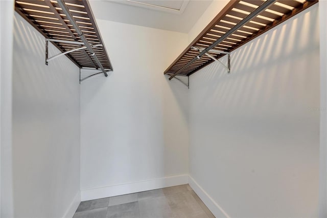 spacious closet featuring tile patterned floors