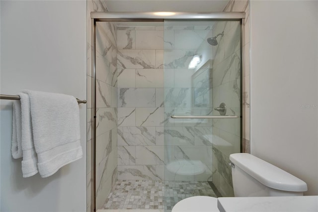 bathroom featuring a shower stall and toilet