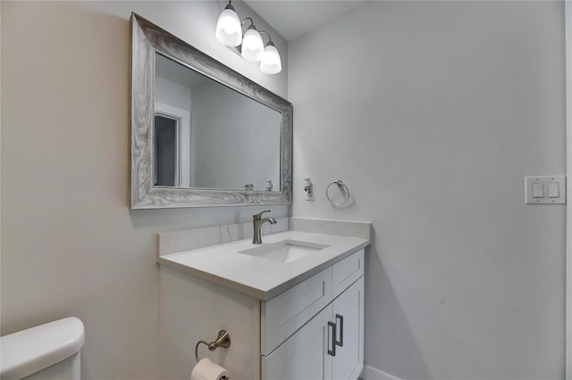 half bath featuring toilet and vanity