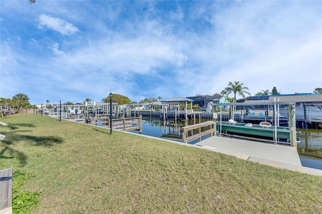 view of dock featuring a water view, a yard, and boat lift