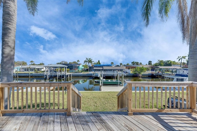 deck featuring a dock, a water view, a yard, and a residential view