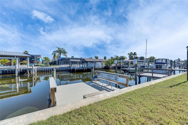 view of dock with a yard, a water view, and boat lift