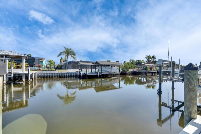 dock area with a water view and boat lift