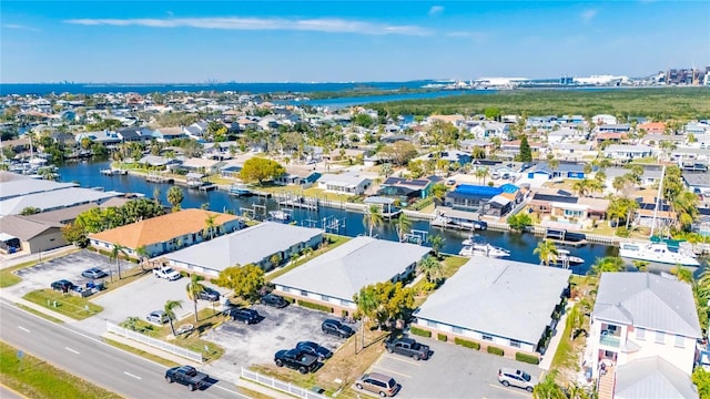 drone / aerial view featuring a residential view and a water view