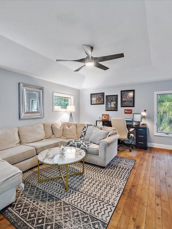 living area featuring a ceiling fan, a healthy amount of sunlight, and hardwood / wood-style floors