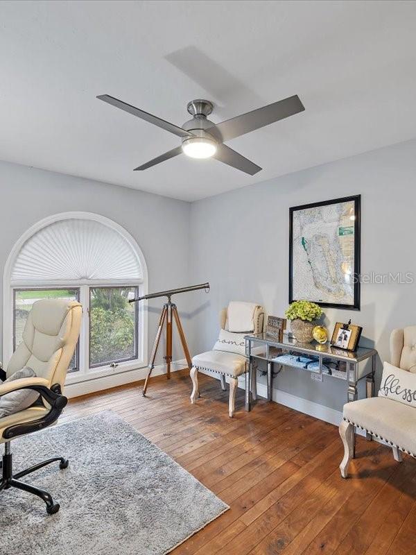 office with wood-type flooring, baseboards, and a ceiling fan