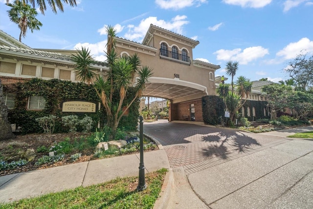 view of front of property featuring decorative driveway and stucco siding