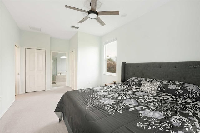 carpeted bedroom featuring a ceiling fan, visible vents, and connected bathroom