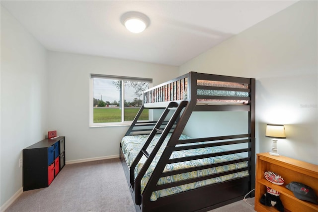 bedroom featuring carpet and baseboards