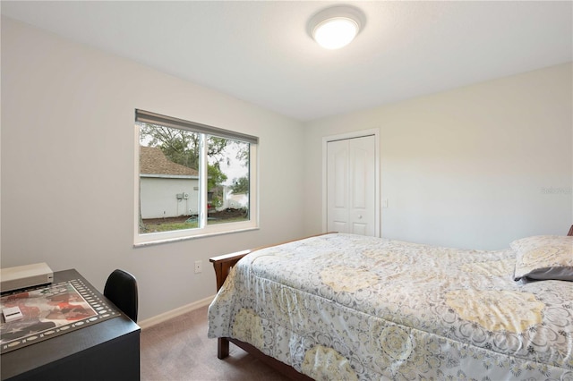 bedroom featuring carpet, baseboards, and a closet