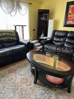 living room featuring an inviting chandelier and wood finished floors