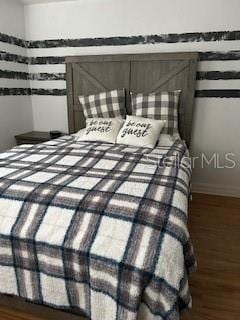 bedroom featuring dark wood-type flooring