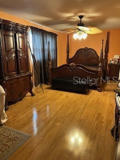 bedroom with ceiling fan and wood finished floors