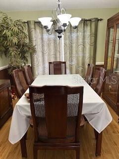 2510 Cypress Bend Dr E, Clearwater, FL 33761 - dining space featuring wood finished floors and a chandelier