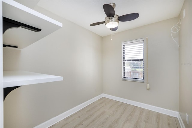 unfurnished room with light wood-type flooring, a ceiling fan, and baseboards