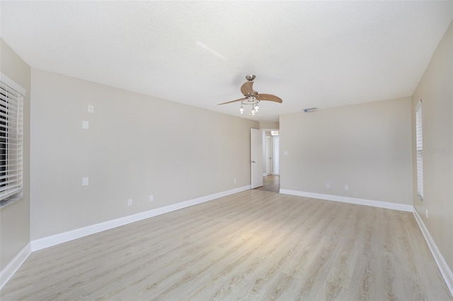 unfurnished room with light wood-type flooring, baseboards, and a ceiling fan