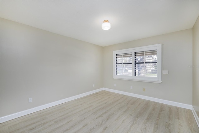 unfurnished room featuring light wood finished floors and baseboards