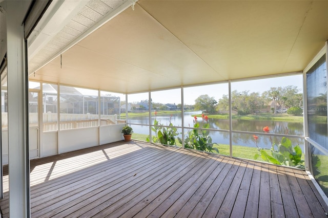 unfurnished sunroom with a water view