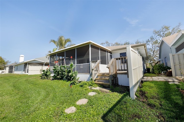 view of front of property with a sunroom and a front yard