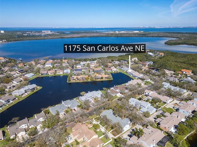 drone / aerial view with a water view and a residential view