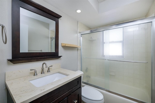 bathroom with toilet, recessed lighting, combined bath / shower with glass door, and vanity