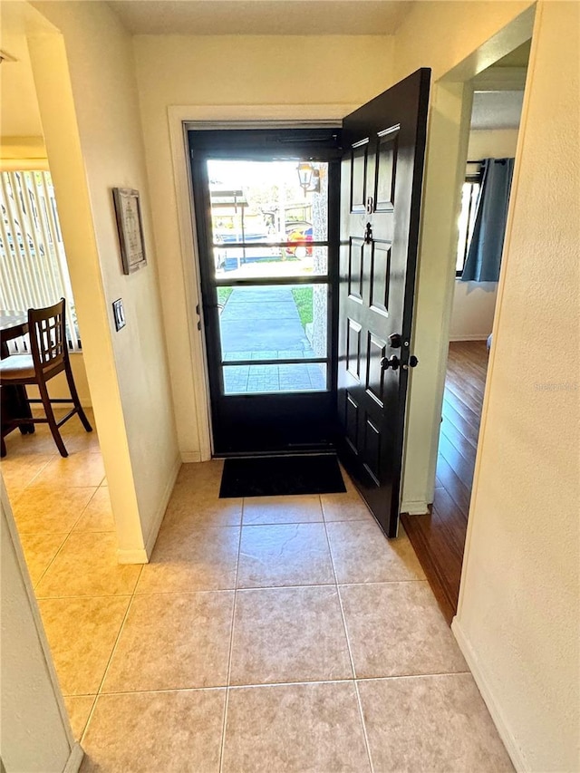 interior space with light tile patterned flooring and baseboards