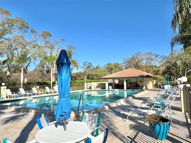 pool featuring a patio area, fence, and a gazebo