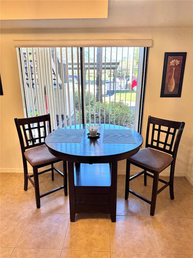 dining space with light tile patterned floors and baseboards