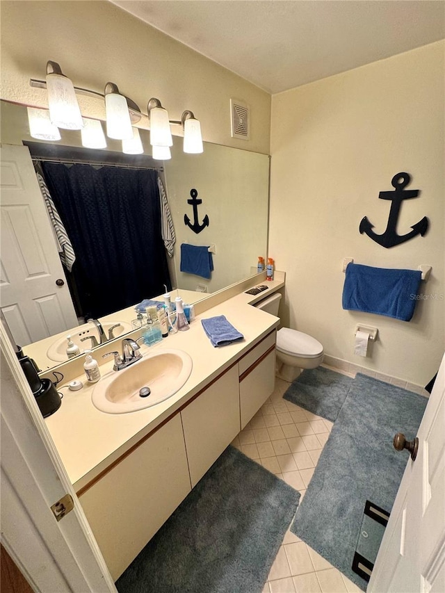 bathroom featuring toilet, vanity, visible vents, and tile patterned floors