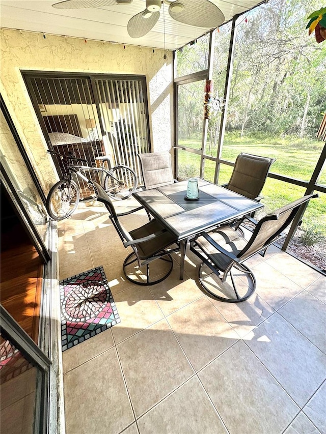 sunroom with a ceiling fan