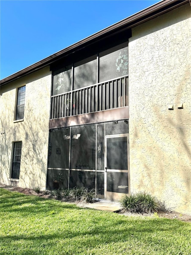 view of home's exterior featuring a yard and stucco siding