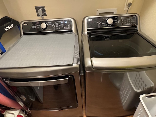 clothes washing area featuring laundry area and independent washer and dryer