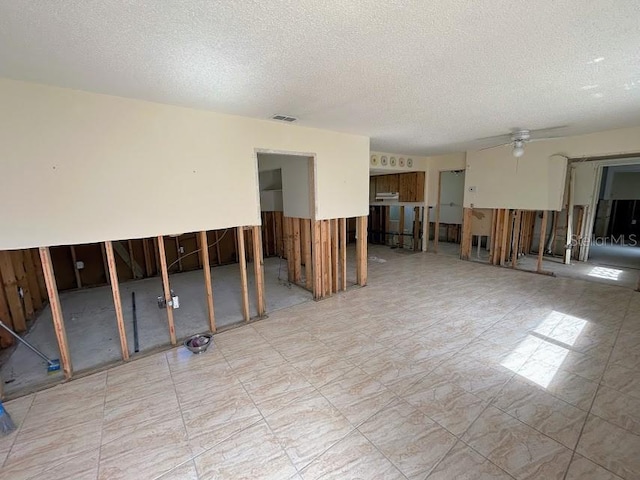 unfurnished room with visible vents and a textured ceiling