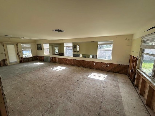 unfurnished room featuring visible vents and a wealth of natural light