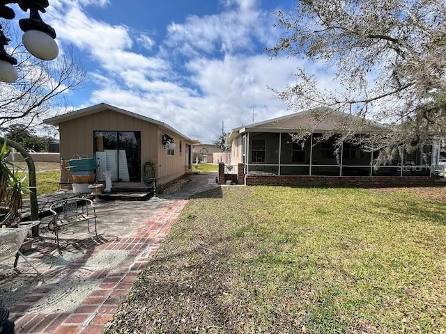 view of yard with a patio area and a sunroom