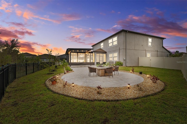 back of house with a patio area, a fenced backyard, and a yard