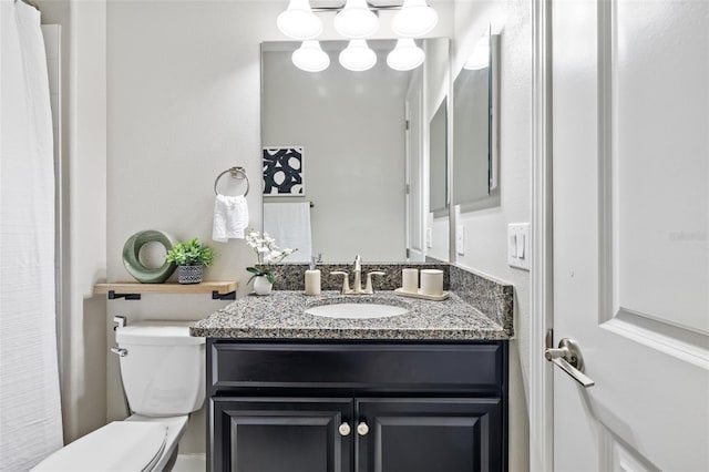 bathroom featuring toilet and vanity